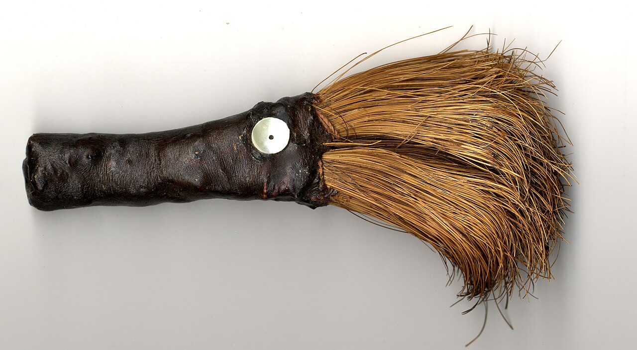 Wavyleaf soap plant: utility brush constructed by Julia F. Parker consisting of Chlorogalum bulb coat fibers, Pinus lambertiana pitch, a shell adornment. 6 inches long exactly. Yose
